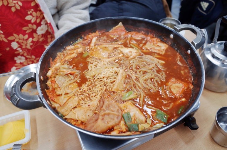 Tteokbokki with fried snacks and fish cakes at a Korean bunsik restaurant in Seoul