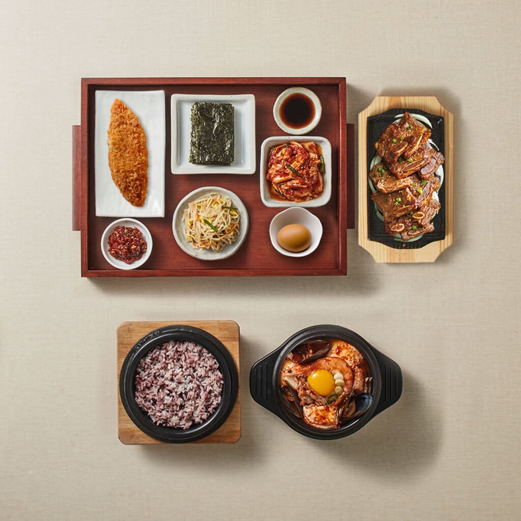 Sundubu jjigae meal with rice and Korean side dishes at Bukchangdong Sundubu