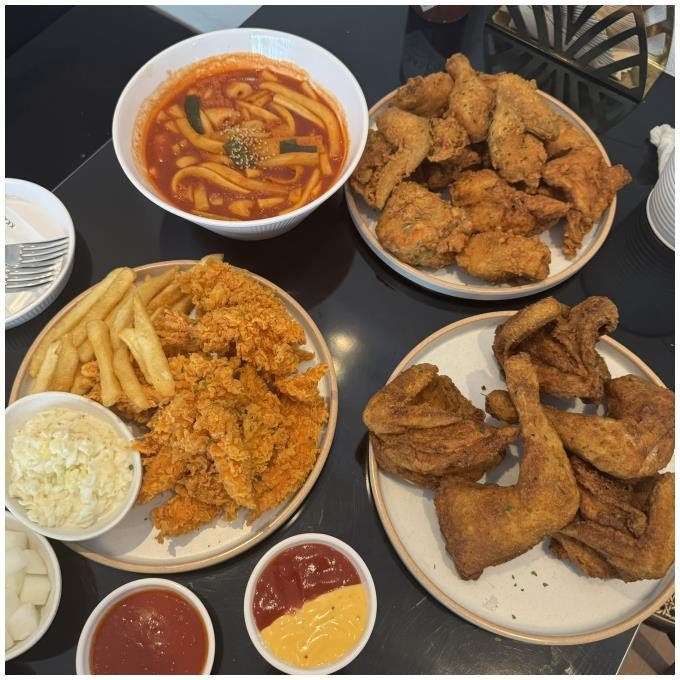 Assorted Kkanbu Chicken dishes with fried chicken and tteokbokki in Myeongdong