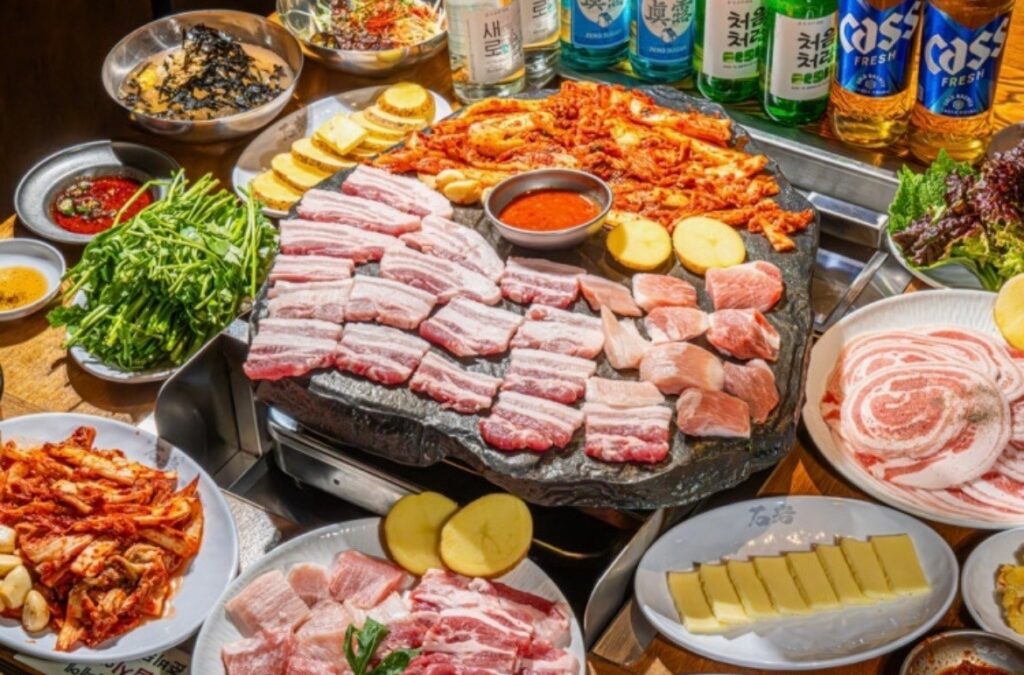 Korean BBQ with grilled pork, lettuce wraps, and side dishes in Seoul