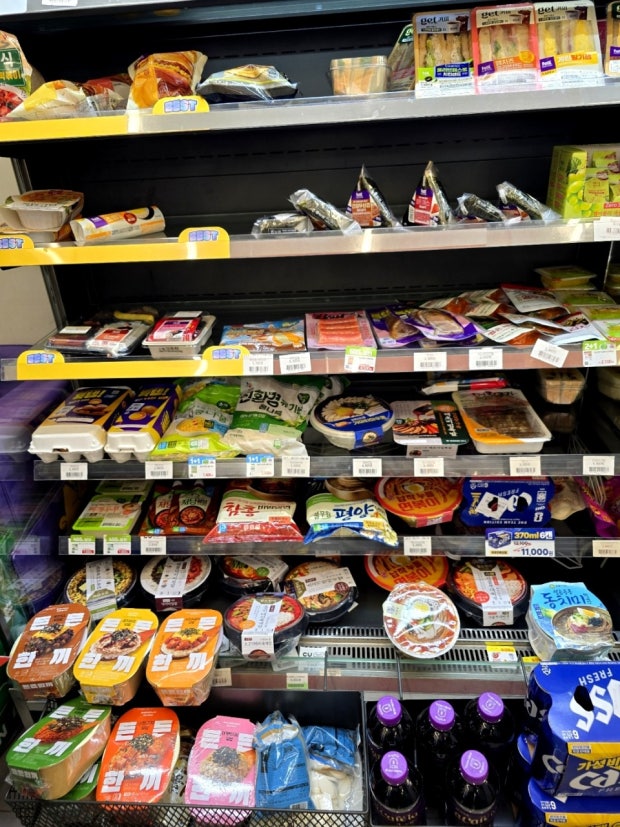 Korean convenience store refrigerator with lunchboxes, kimbap, and sandwiches