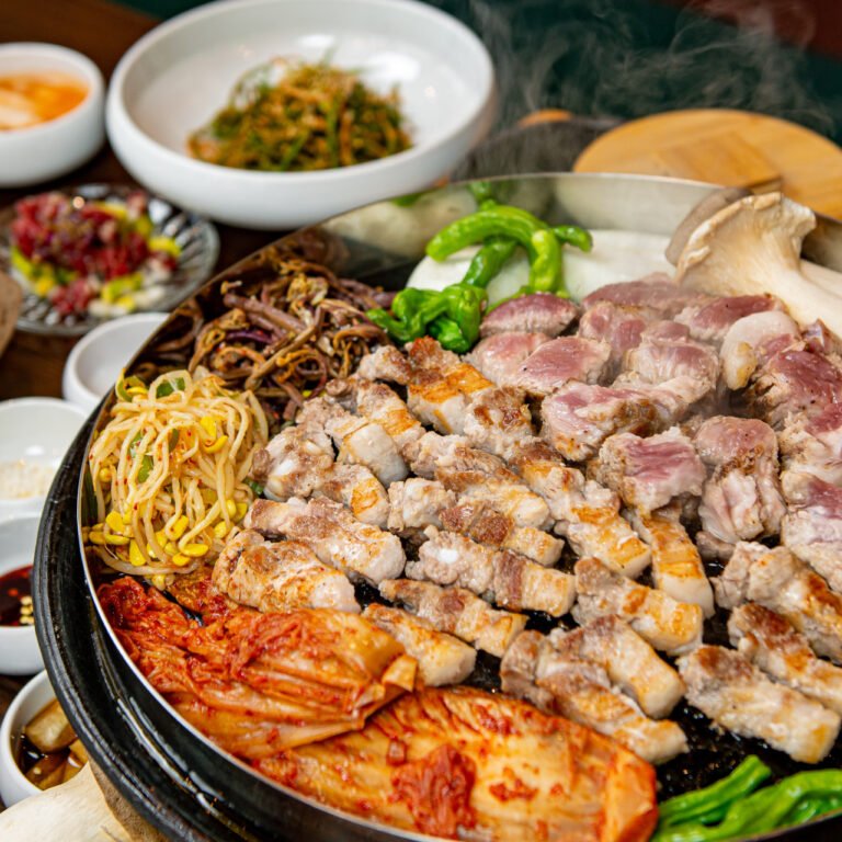 Korean BBQ with samgyeopsal, kimchi, and bean sprouts in Myeongdong, Seoul